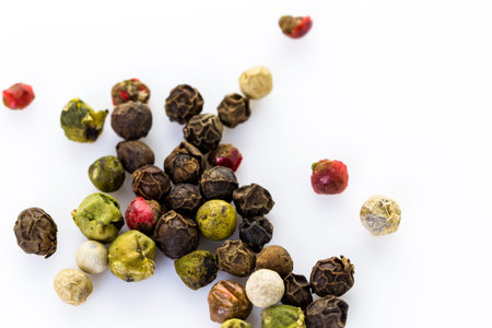 Bold and varied peppercorns on a white background.の写真素材