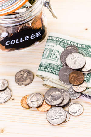 Saving money into glass jar for future investment.の写真素材