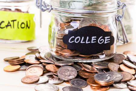 Saving money into glass jar for future investment.の写真素材