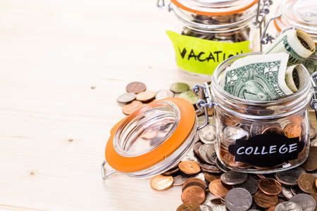 Saving money into glass jar for future investment.の写真素材