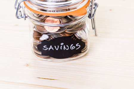 Saving money into glass jar for future investment.の写真素材