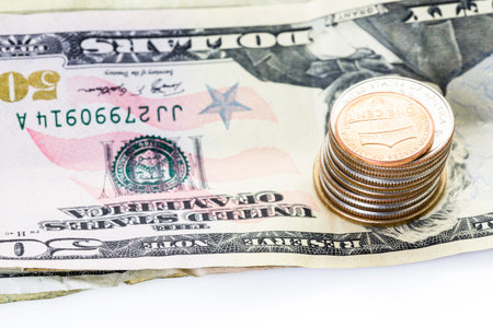 American bills and coins on a white backgreound.
