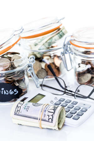 Saving money into glass jar for future investment.の写真素材