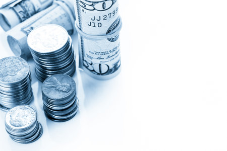 American bills and coins on a white backgreound.