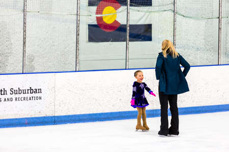 Denver, Colorado, USA-March 20, 2015. Typical practice day with coach for young figure skater.のeditorial素材