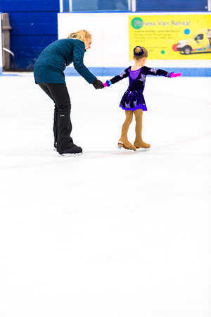 Denver, Colorado, USA-March 20, 2015. Typical practice day with coach for young figure skater.のeditorial素材