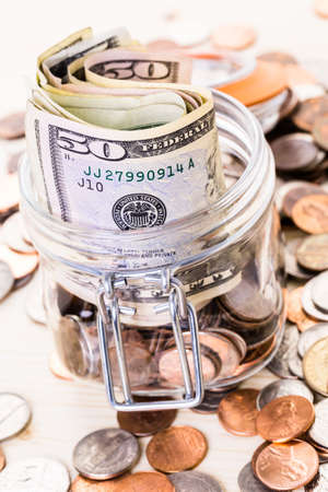 Saving money into glass jar for future investment.の写真素材