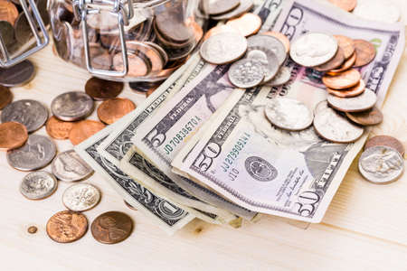 Saving money into glass jar for future investment.の写真素材