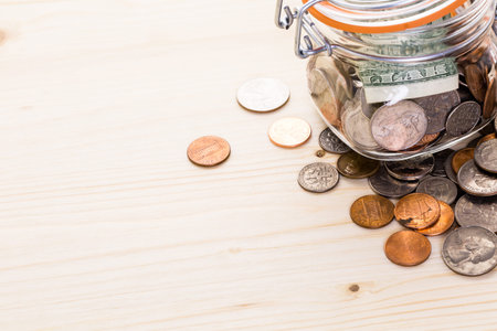Saving money into glass jar for future investment.の写真素材