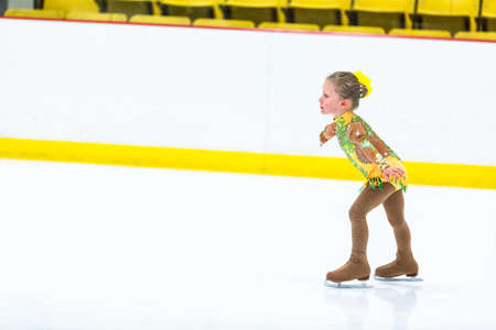 Cute girl practicing ice skating before her first competition.の写真素材