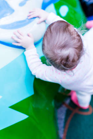 Toddler playing at the indoor toddler playground.の写真素材