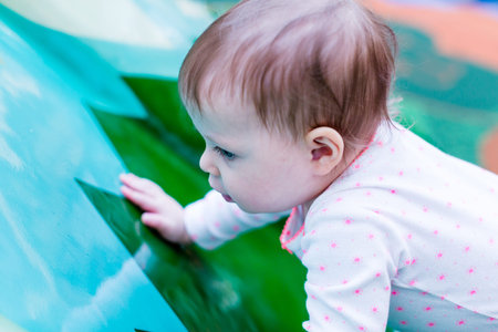 Toddler playing at the indoor toddler playground.