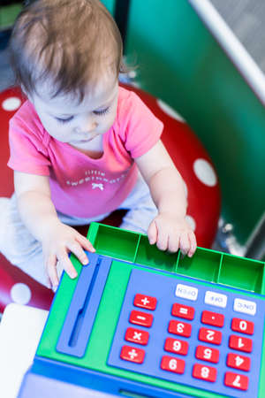 Toddler girl enjoying her play at the kids corner.の写真素材