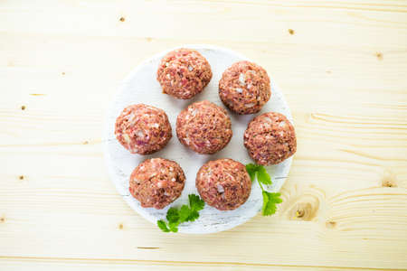 Cooking large homemade Italian meatballs for dinner.の写真素材