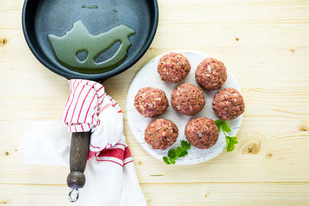 Cooking large homemade Italian meatballs for dinner.の写真素材