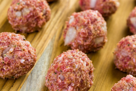 Raw Italian meatballs ready to be cooked for dinner.の写真素材