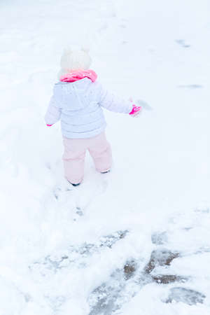 Cute toddler enjoying play in fresh snow.の写真素材
