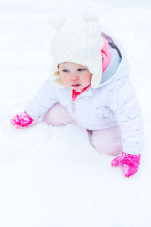 Cute toddler enjoying play in fresh snow.の写真素材