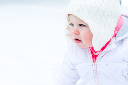 Cute toddler enjoying play in fresh snow.の写真素材