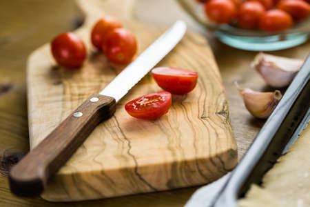 Preparing fresh roasted cherry tomatoes.の写真素材