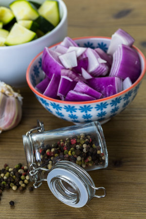 Fresh ingredients for preparing roasted mixed vegetables on the table.の写真素材