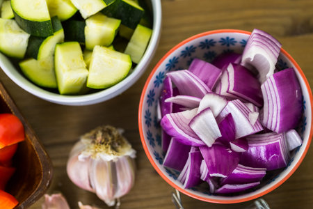 Fresh ingredients for preparing roasted mixed vegetables on the table.