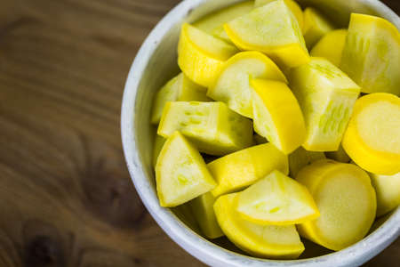 Fresh ingredients for preparing roasted mixed vegetables on the table.の写真素材