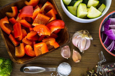 Fresh ingredients for preparing roasted mixed vegetables on the table.の写真素材