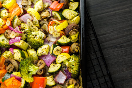 Preparing fresh roasted mixed vegetables for dinner.の写真素材