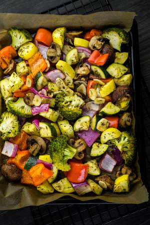 Preparing fresh roasted mixed vegetables for dinner.の写真素材