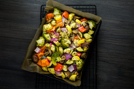 Preparing fresh roasted mixed vegetables for dinner.の写真素材