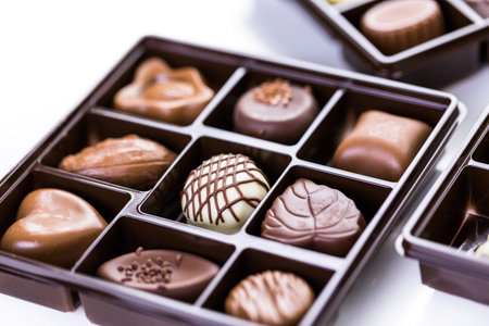 Assorted chocolates in box on a white background.の写真素材
