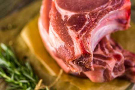 Organic pork lion chops of thick cut with rosemary.の写真素材