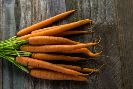 Fresh organic vegetable in season on old farm table.の写真素材