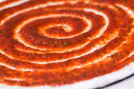 Preparing pizza with thin crust in Italian restaurant.の写真素材