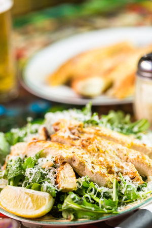 Arugula salad with grilled chicken in Italian restaurant.の写真素材