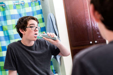 Teenage boy getting ready for school in the morning.の写真素材