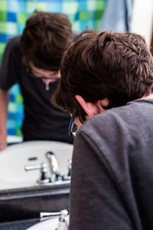 Teenage boy getting ready for school in the morning.の写真素材