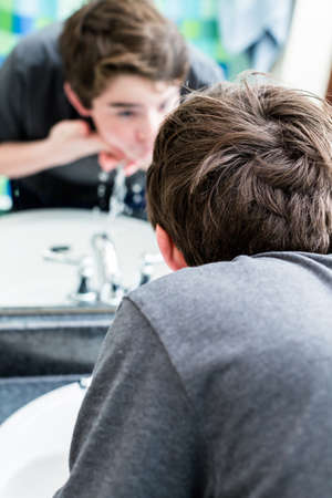 Teenage boy getting ready for school in the morning.の写真素材