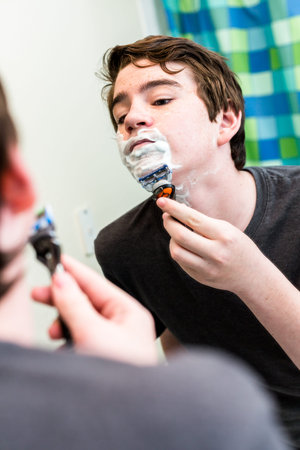 Teenage boy getting ready for school in the morning.の写真素材