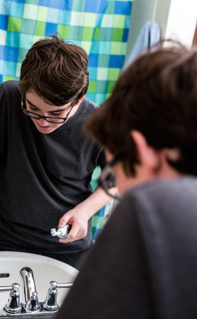 Teenage boy getting ready for school in the morning.の写真素材