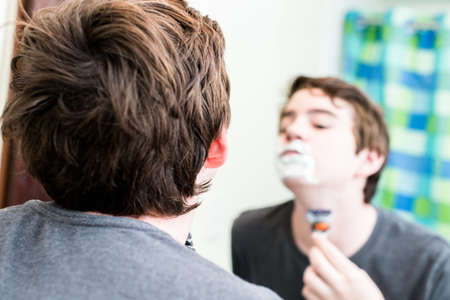 Teenage boy getting ready for school in the morning.の写真素材