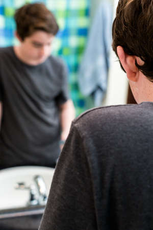 Teenage boy getting ready for school in the morning.の写真素材