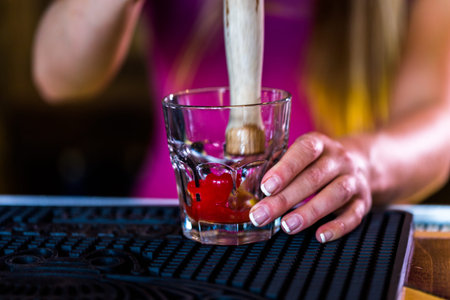 Bartender making new old fashioned cocktail in Italian restaurant.