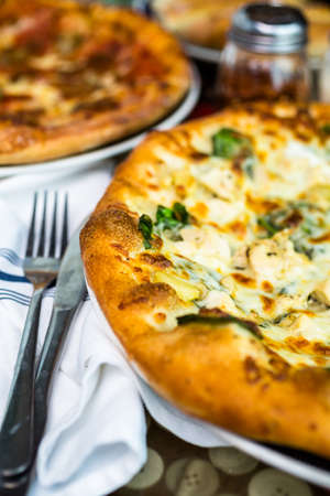 Fresh chicken pine nut pizza in Italian restaurant.の写真素材