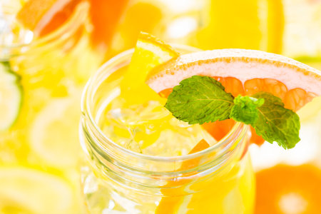 Infused water with fresh citrus fruits and ice.の写真素材