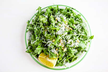 Arugula salad with pine nuts on the plate in Italian restaurant.の写真素材