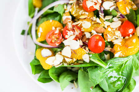Orange spinach salad on the plate in Italian restaurant.の写真素材
