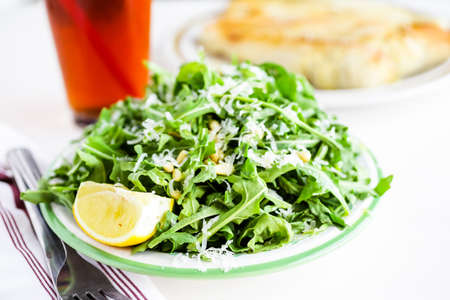 Arugula salad with pine nuts on the plate in Italian restaurant.の写真素材