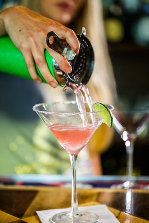 Bartender preparing Cosmopolitan drink for customer.の写真素材